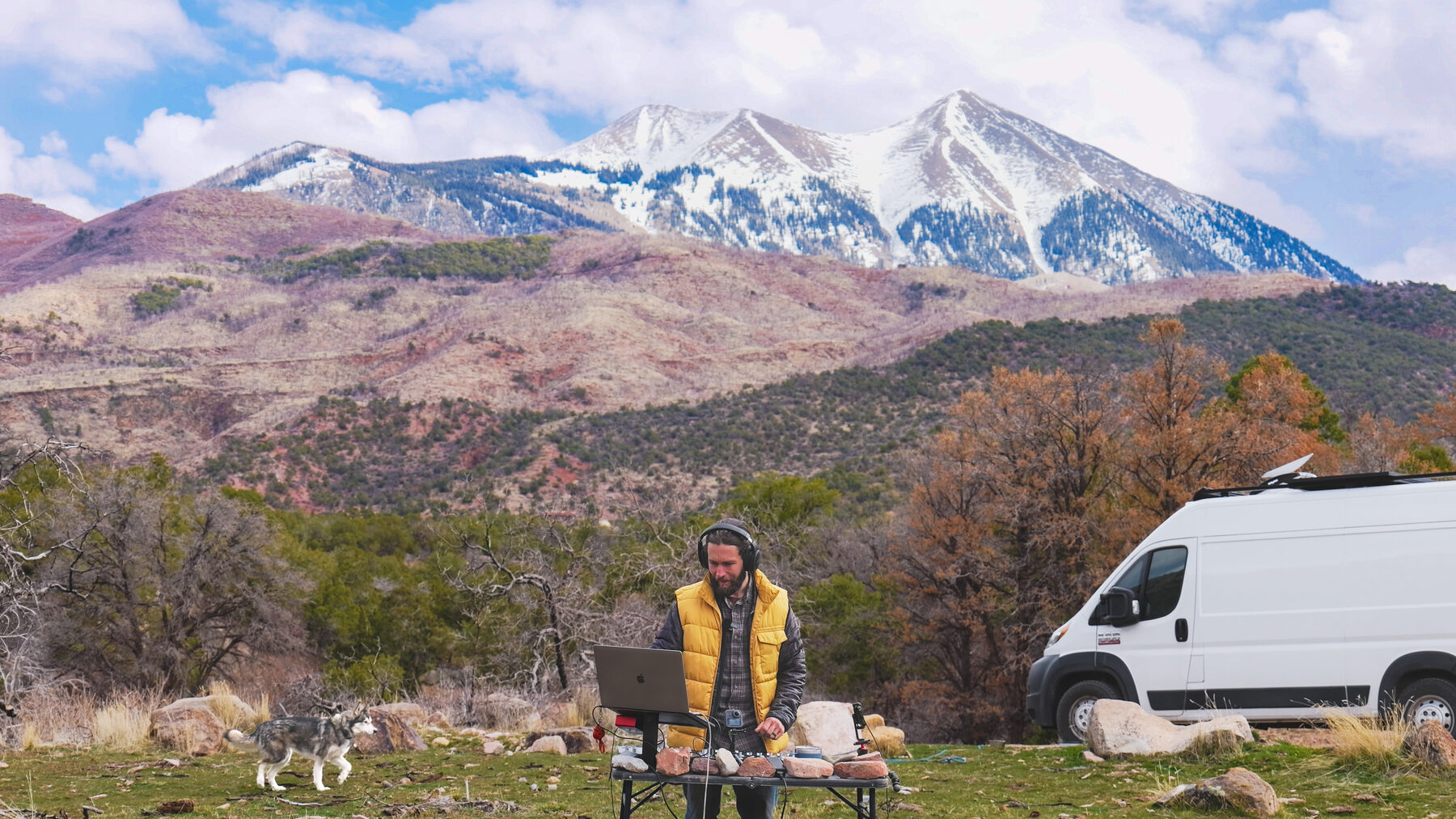 Josh mixing outdoors with snowy mountains in the background