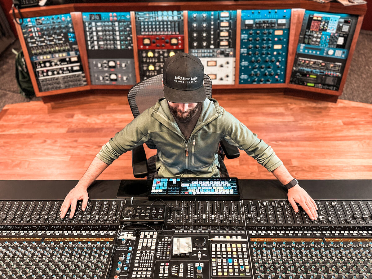 Josh behind the SSL console at Mansion Sound with racks of outboard gear